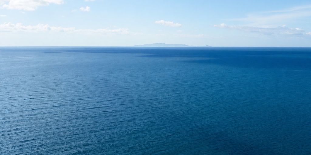 Distant land across water from Alaskan coast.